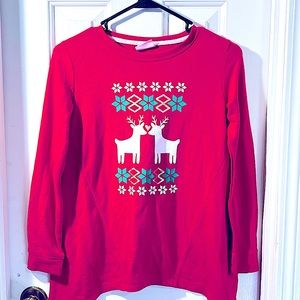 The shirt has a white reindeer x2 and has green and red color in the shirt.
